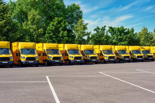 Fleet of yellow EV trucks in a row 521687097